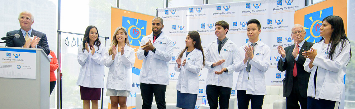 seven of the scholarship recipients with Richard Seidman and John Baackes of L.A. Care onstage at launch event