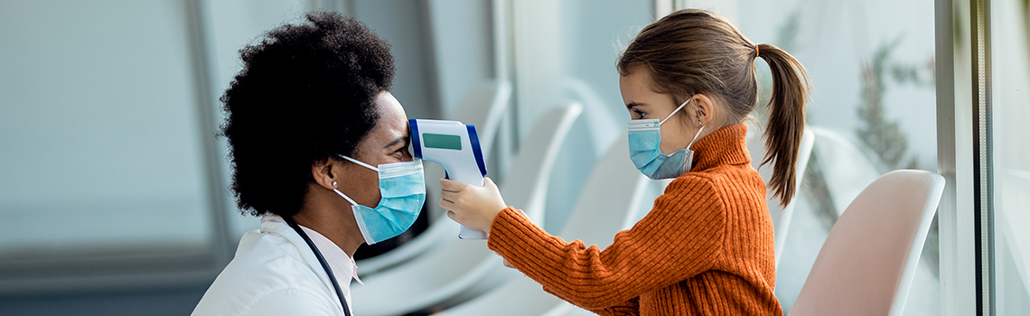 a doctor getting her temperature by a young girl