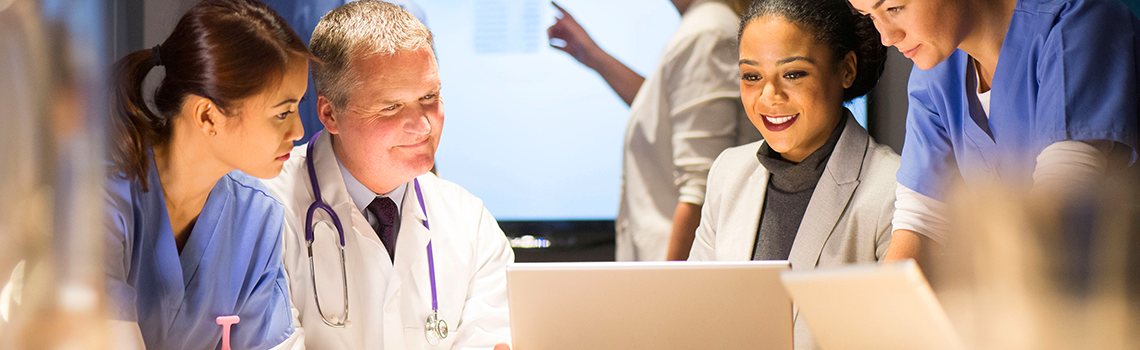 medical staff looking at laptop