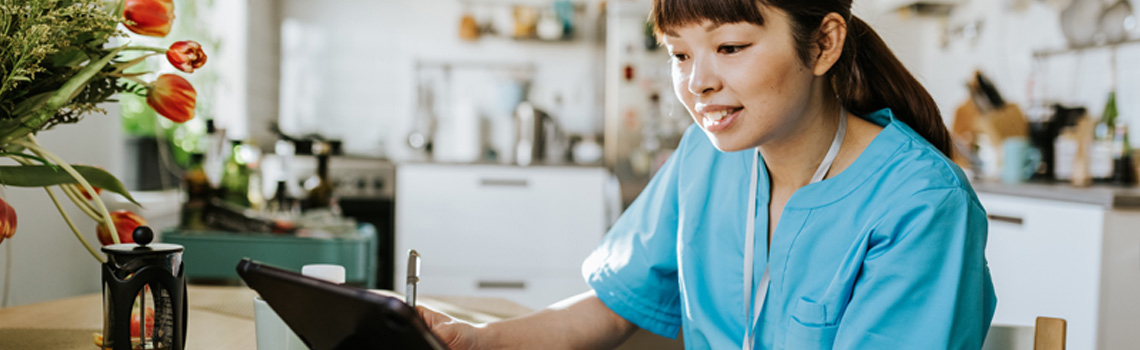 nurse looking at laptop