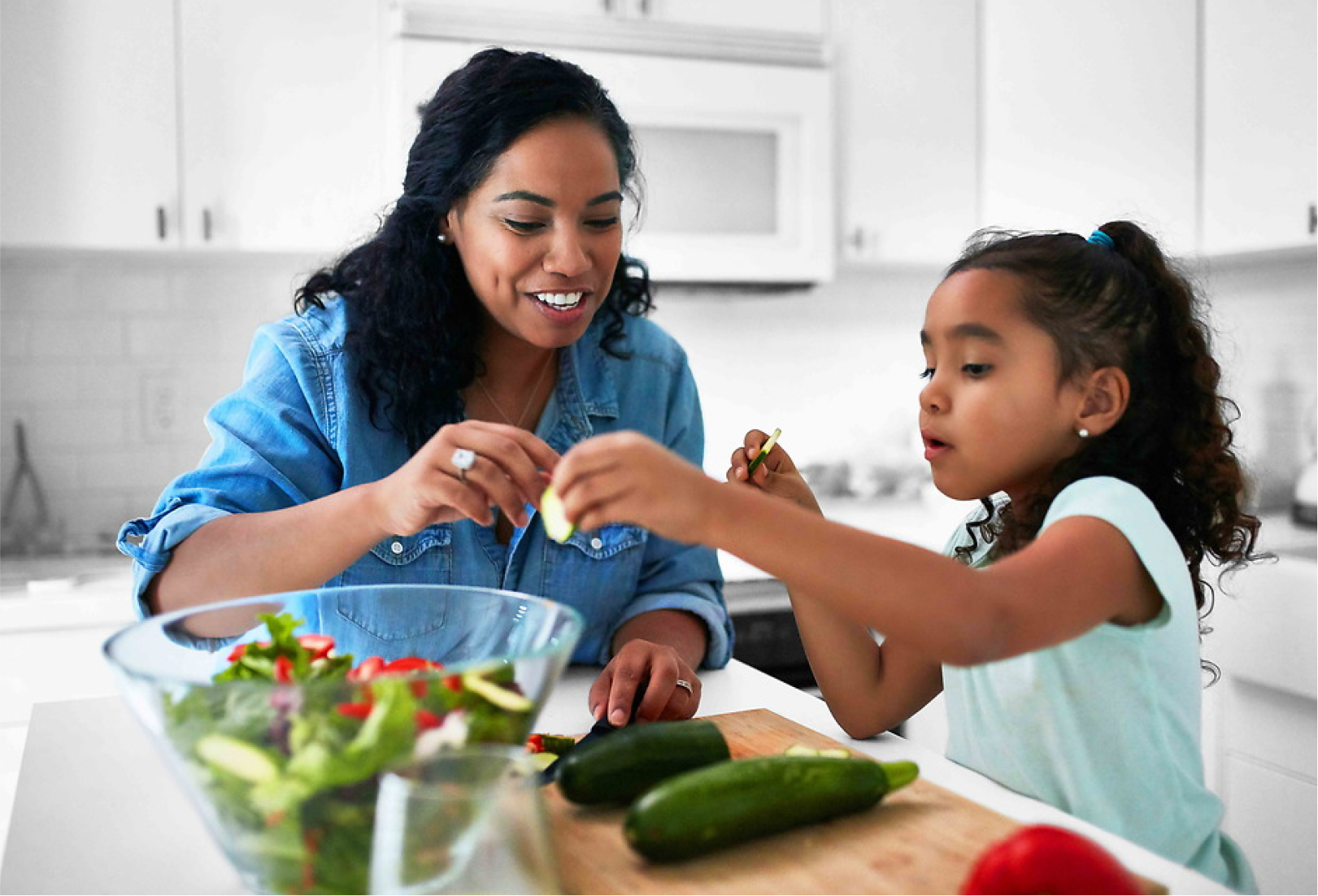 Mother and daughter preparing food