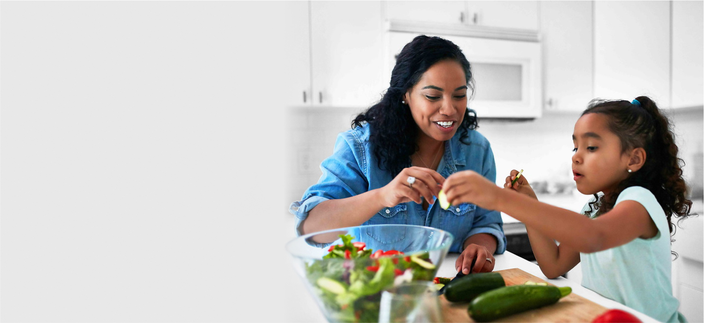 Mother and daughter preparing food