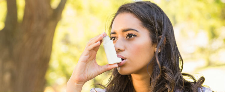 Girl using asthma inhaler