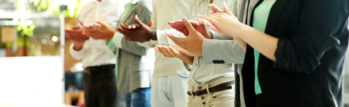 Group of cheerful business team applauding