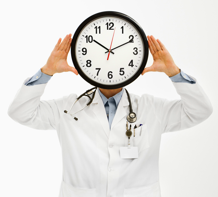 a doctor holding a large clock in front of his face