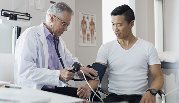 doctor checking blood pressure of patient