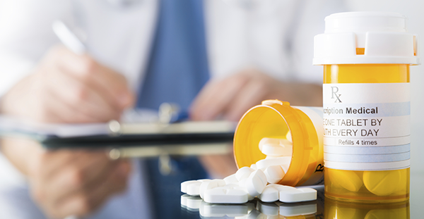 image of a prescription pill bottle on the desk of a doctor