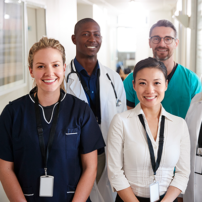 Portrait Of Medical Team Standing In Hospital Corridor Portrait Of Medical Team Standing In Hospital Corridor