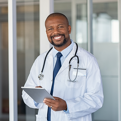 Portrait of happy doctor at private clinic