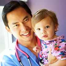 a doctor holding a little girl