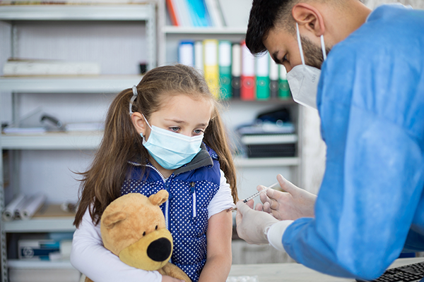 doctor giving a girl her shot