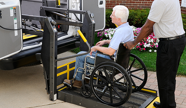 a man in a wheelchair getting into a transport van