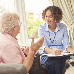 nurse speaking to older woman