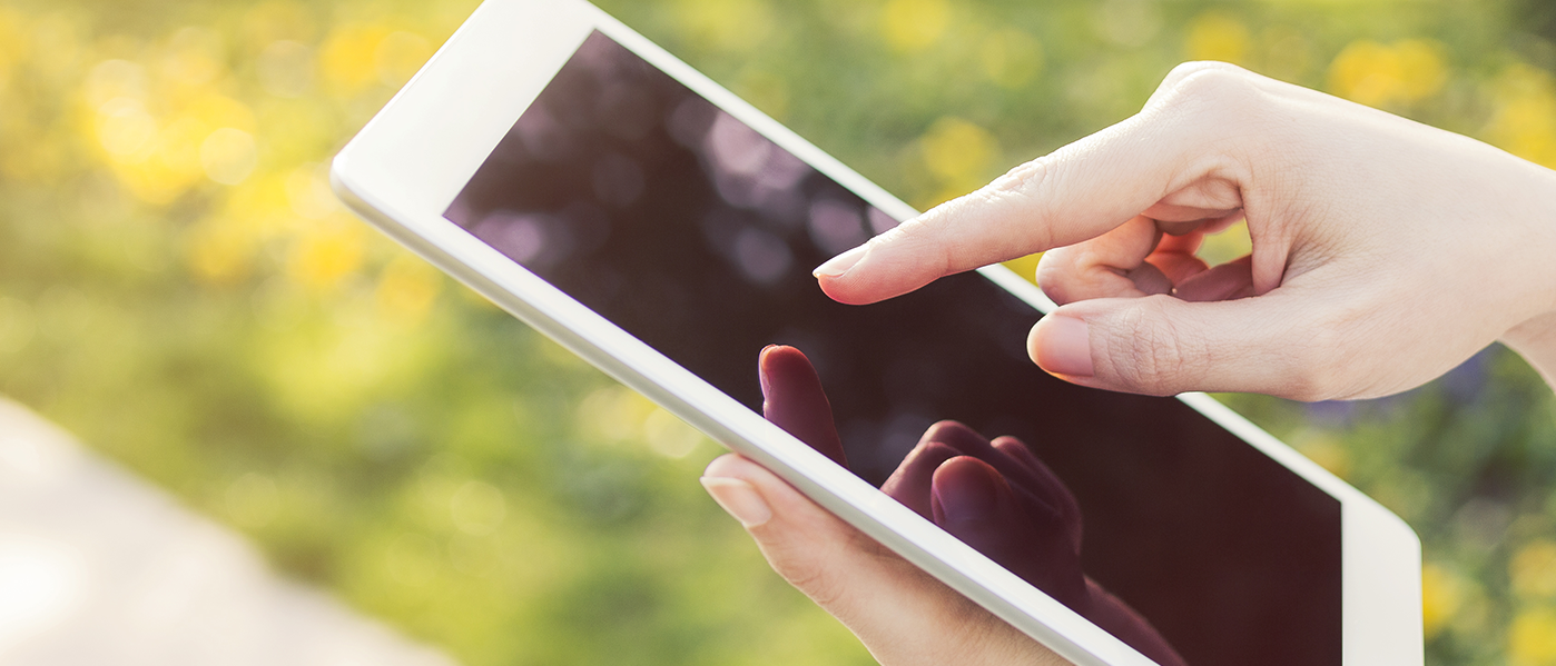 Payments hand tapping an iPad