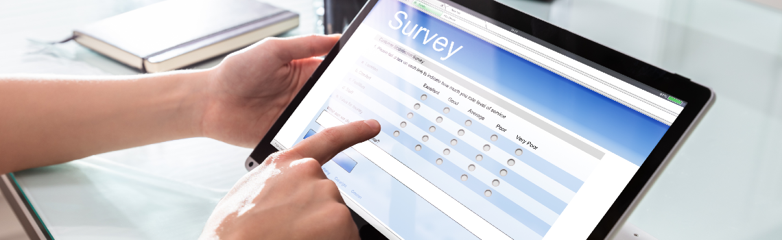 hands pointing to a tablet with a survey on the screen
