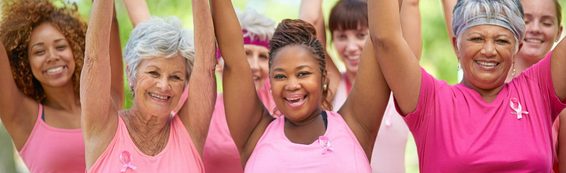 Breast Cancer Survivors smiling and holding hands