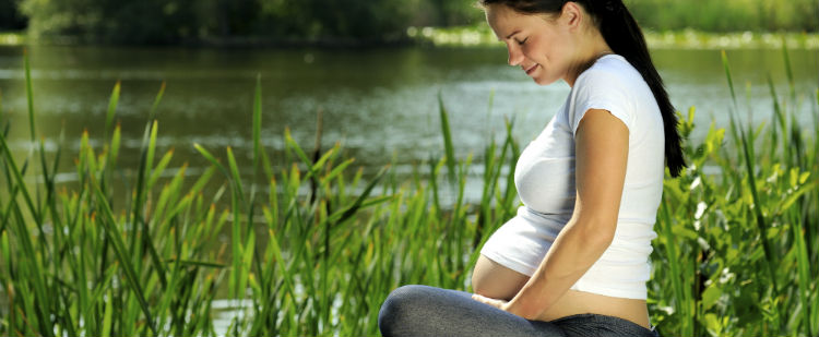 pregnant woman by lake