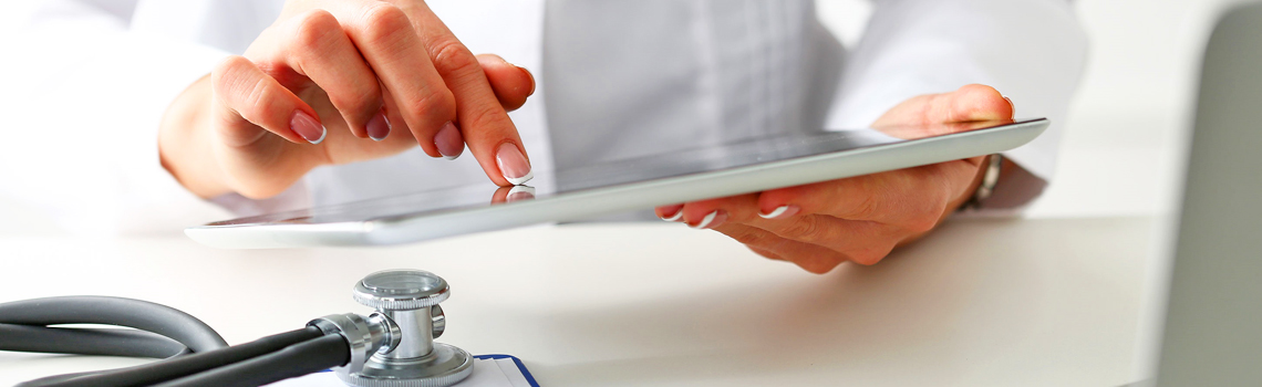 doctor's hands holding a tablet computer