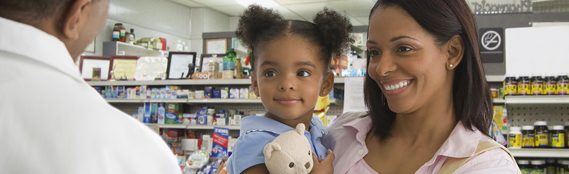 mother and daughter talking to pharmacist