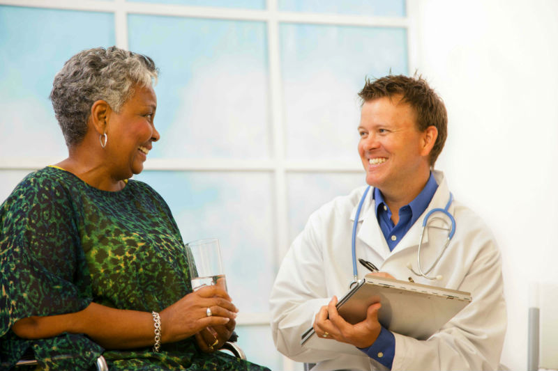 Woman talking to doctor